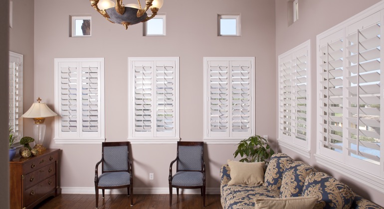 Chic sunroom with plantation shutters