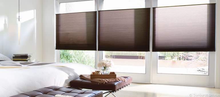 Modern Raleigh bedroom with high windows and vertical cellular shades.