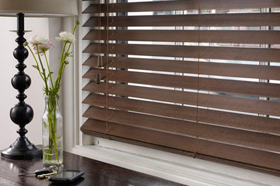 Dark faux wood blinds in a living room.