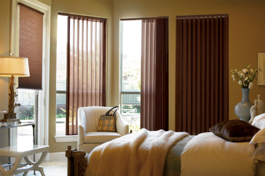 Choose durable and high-quality fabric or vinyl vertical blinds in Raleigh. Maroon fabric vertical blinds inside a bedroom