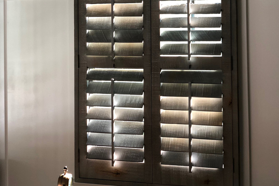 Reclaimed wood shutters in a bathroom.