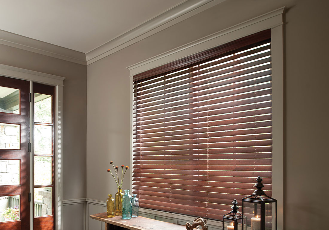 Dark wood shutters in a foyer.