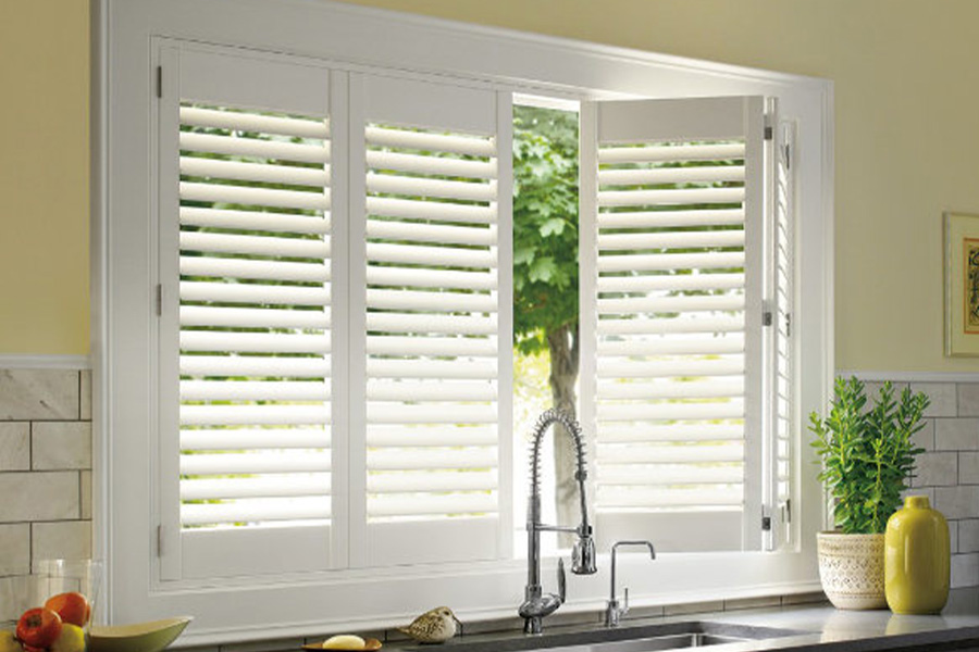Polywood shutters are built to withstand the test of time in Raleigh. White Polywood shutters above a kitchen sink.