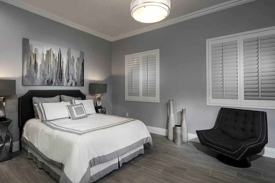 Close your custom Polywood shutters to beat the heat and keep your Raleigh bedroom cool. White Polywood shutters on bedroom windows