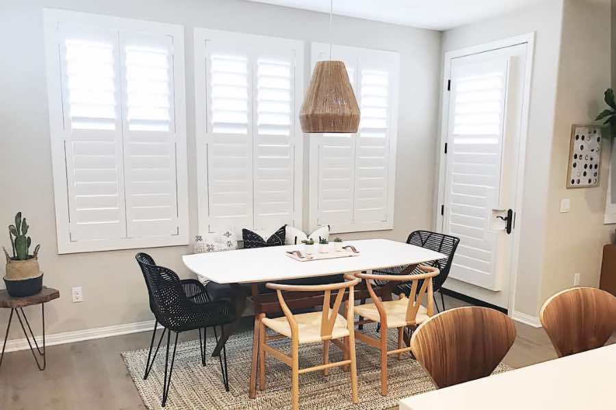 Use Polywood shutters to control natural light levels in your Raleigh dining room. Polywood shutters with top louvers tilted open in a dining room