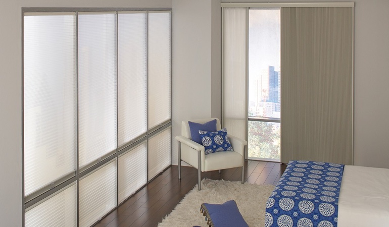 Cell shades are another choice to support a minimalist design. Cellular shades in a streamlined bedroom.