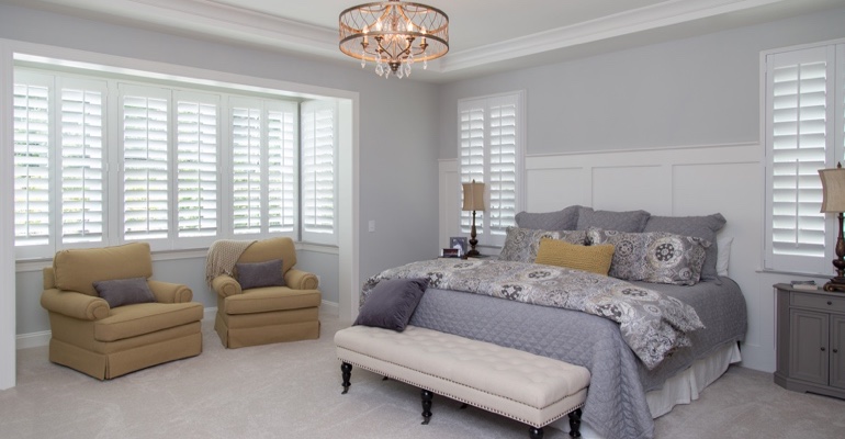 interior shutters offer subtle fashion. White shutters in Raleigh bedroom.