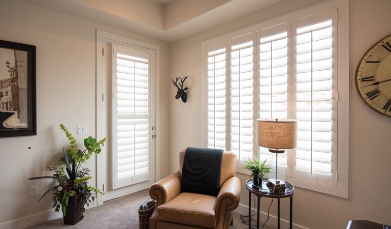 Polywood® plantation shutters come with a lifetime warranty.  Plantation shutters in a corner