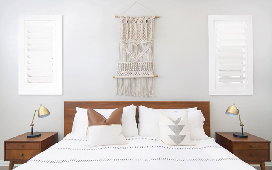 Custom-fitted louvered shutters provide excellent nighttime privacy in Raleigh. Photo Credit: Audrey Crisp Louvered shutters in a bedroom.