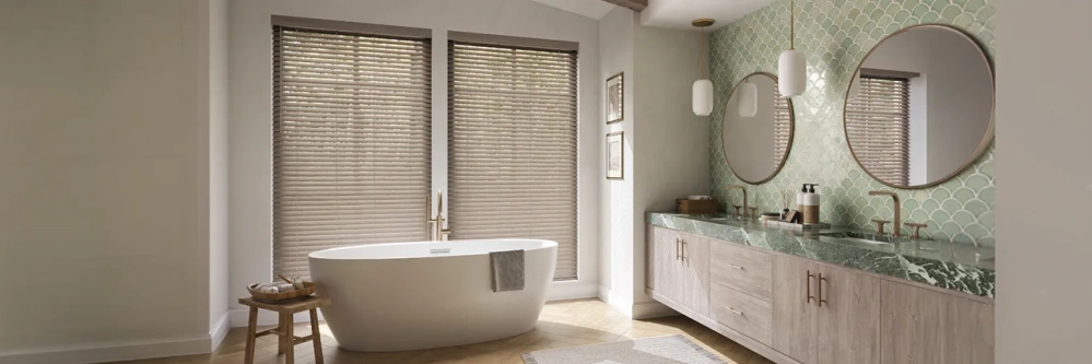Contemporary window blinds cover windows behind a bathtub