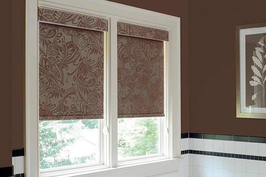 A beautiful and yet functional roller shade for a small dormer-sized window. brown print of roller shade on a small window
