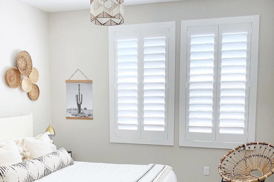 Interior Polywood shutters keeps you warm and cozy during the cold winter months. Photo Credit: @AudreyCrispInteriorDesigns White polywood shutters in a white bedroom.