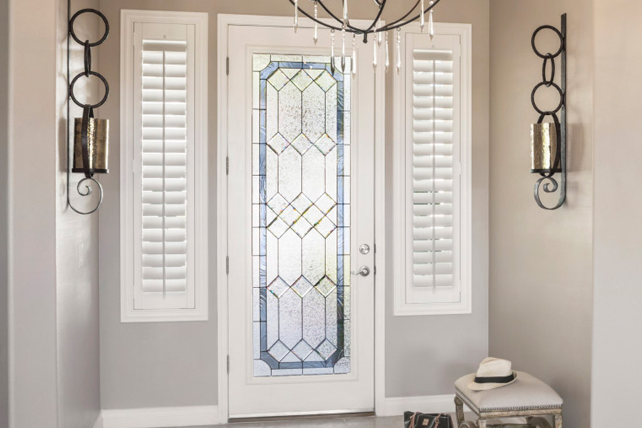 Polywood shutters offer flexibility on the brightness of natural light in Raleigh. Sidelight windows with white polywood shutters in a foyer.