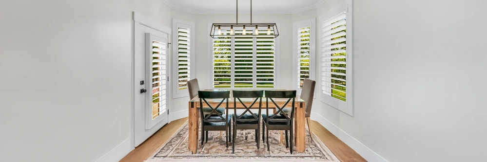 White Polywood shutters on dining room windows