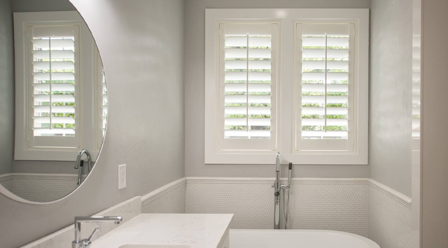 White shutters in a bathroom.